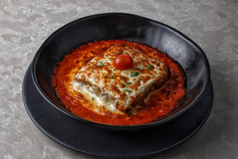 Oven-baked lasagna with layers of cheese and meat sauce